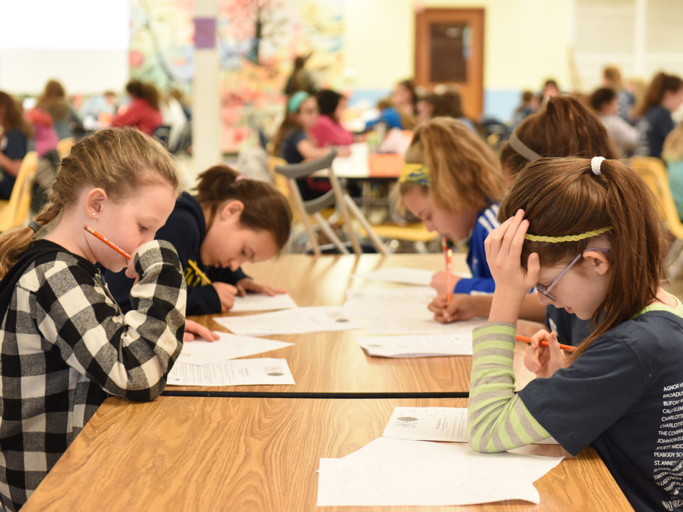 Girls working on an activity during Gem Day 2018